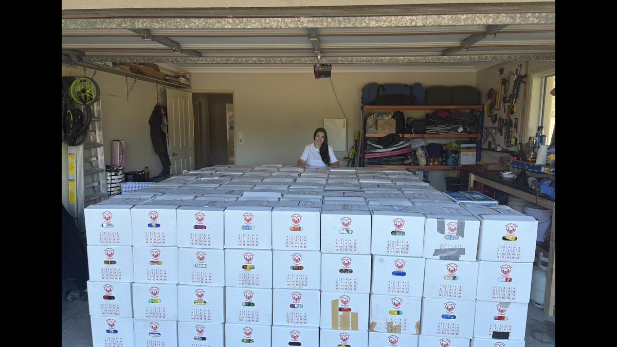 Volunteer organizing boxes in garage
